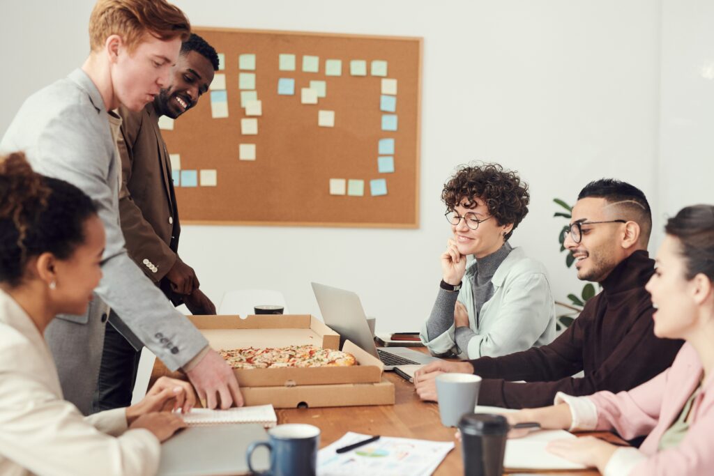 Employees eating pizza in a meeting